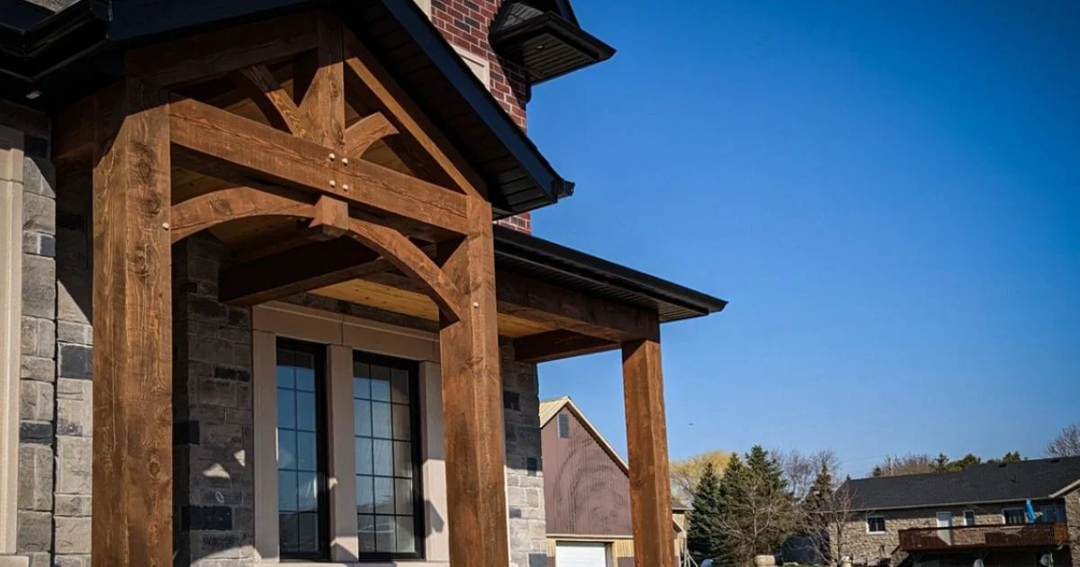 Timber frame front entry on stone house